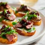 Steak Crostini with Goat Cheese, Sundried Tomatoes, and Arugula Recipe
