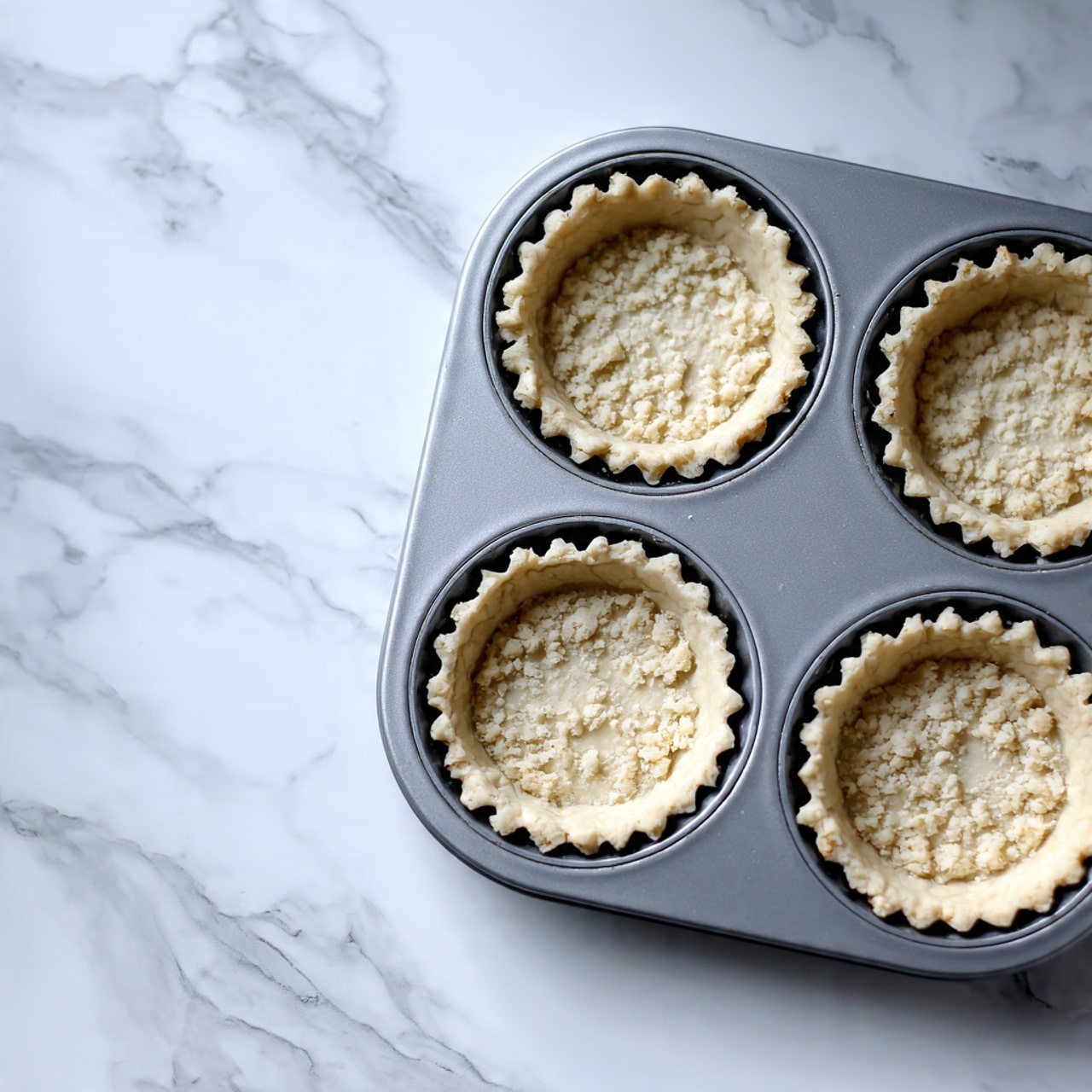 The image shows several bowls and plates of ingredients placed on a white marbled surface. There is one large white bowl filled with white flour, a small white bowl with granulated white sugar, a larger white plate holding many chunks of light yellow butter, and a small white jug filled with white cream. Another large white bowl contains a colorful mix of chopped fruits arranged in sections: bright red strawberries, deep red cherries, orange-yellow peaches, dark red raspberries, green kiwi pieces, and dark blue blueberries. A white bowl near the bottom left contains smooth yellow custard, and next to it is a small white bowl with bright orange jam. A pink cloth is partly visible in the bottom left corner of the image. The photo is taken with an iphone --ar 4:5 --v 7