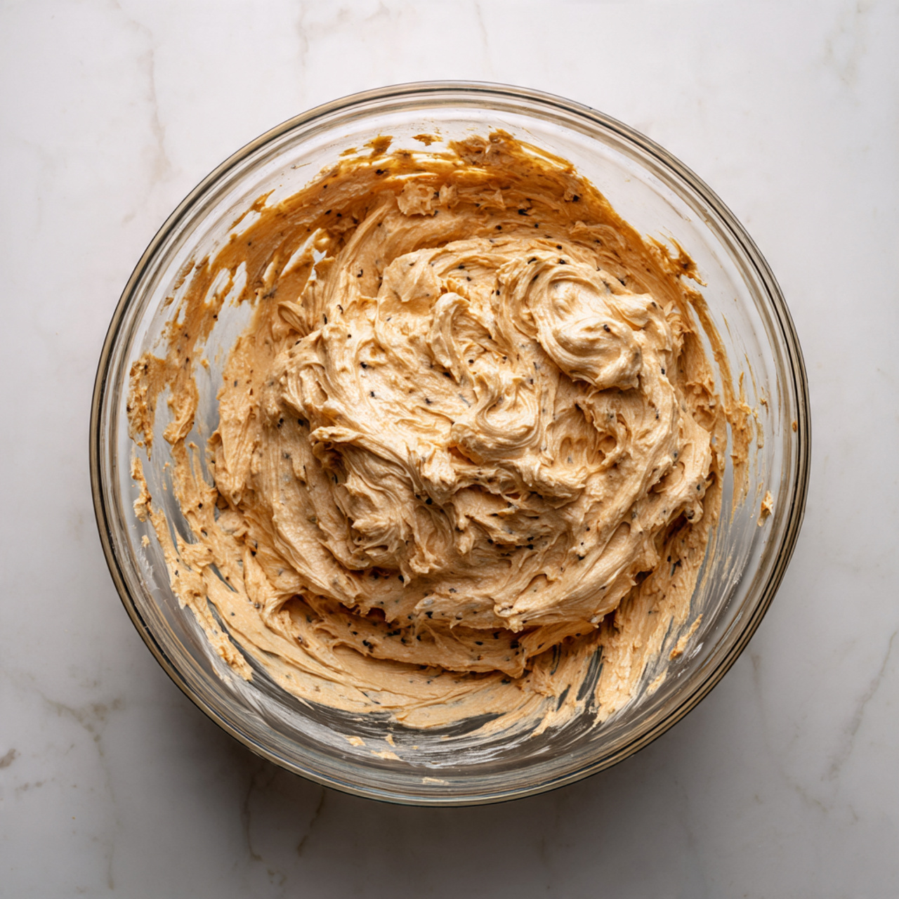A round cheese ball covered with chopped nuts and green herbs sits in the center of a white plate. Around the cheese ball, there is one layer of square-shaped crackers arranged neatly, touching the plate's edge. The cheese ball has a rough texture from the mixed nuts and herbs, showing small pieces in brown and green. The plate rests on a white marbled surface. Photo taken with an iphone --ar 4:5 --v 7