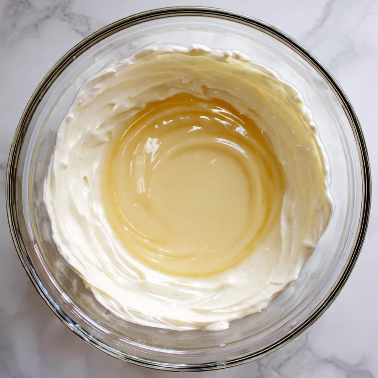 A white saucepan on a white marbled surface filled halfway with bright red raspberries layered on the left side, and a pile of white granulated sugar on the right side, covering some raspberries. The raspberries have a soft texture with visible tiny seeds, and the sugar looks fine and grainy, slightly compacted on top of the berries. The saucepan handle is visible on the left side. Photo taken with an iphone --ar 4:5 --v 7