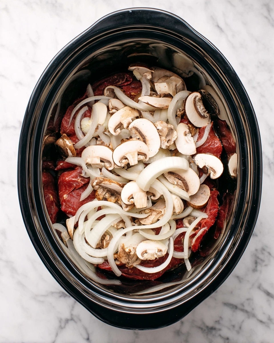 Inside a black slow cooker, there are three visible layers: the bottom layer is made of dark red raw meat slices, on top of that is a layer of thin white onion slices with a slight shine, and the topmost layer is scattered with fresh, light brown sliced mushrooms that show their white inner flesh. The slow cooker is placed on a white marbled surface. photo taken with an iphone --ar 4:5 --v 7