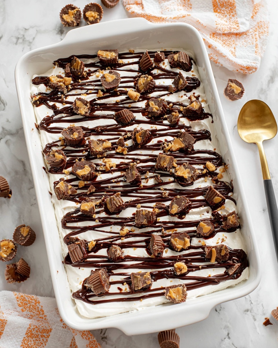 Reese's Lasagna Recipe 5 A white rectangular dish holds a dessert with one thick layer of smooth white cream covering the base. On top, there are neat, even lines of glossy dark brown chocolate sauce running horizontally across the entire surface. Scattered over the chocolate drizzle are many small pieces of chocolate peanut butter cups, broken into irregular chunks showing both the dark chocolate exterior and lighter peanut butter filling. The dessert is placed on a white marbled surface with a few whole and unwrapped mini peanut butter cups nearby. photo taken with an iphone --ar 4:5 --v 7