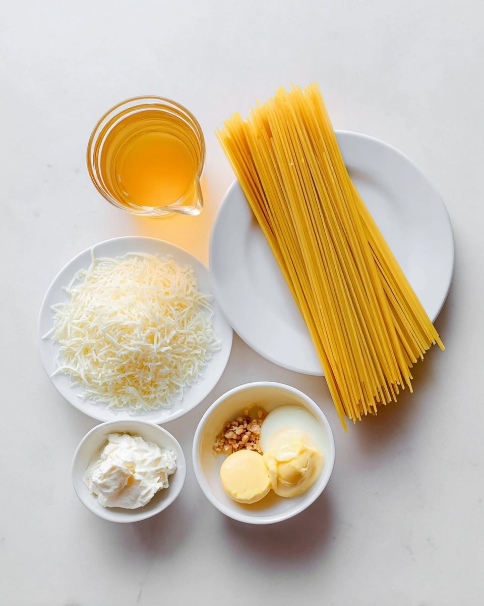 A top view shows uncooked spaghetti yellow sticks on a white plate placed in the middle, with a small glass pitcher of clear golden broth on the left. Below the plate is a small white cup filled with finely shredded white cheese. To the right of the plate, there is a small glass bowl with white cream and a small round white bowl containing three scoops of yellow butter and light brown minced garlic. Everything is placed on a white marbled surface. photo taken with an iphone --ar 4:5 --v 7