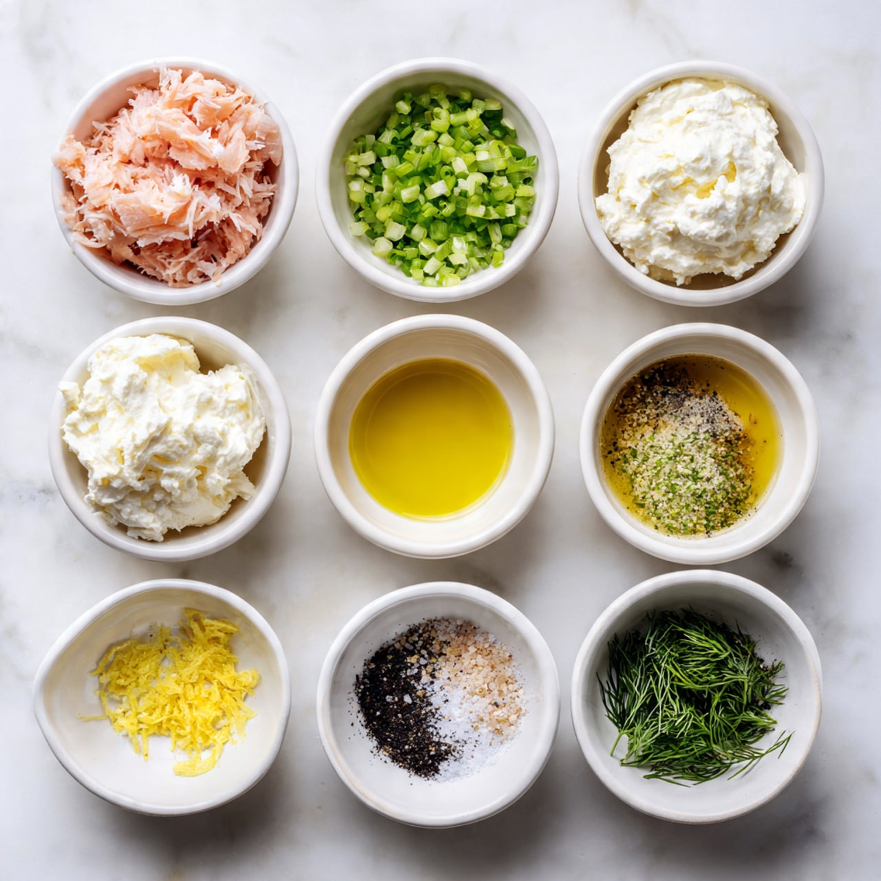 Nine small white bowls are arranged in a grid on a white marbled surface. The top row has shredded light pink tuna in the left bowl and thick white cream cheese in the right bowl. The middle row has finely chopped green onions on the left, golden olive oil in the center, and light yellow vinegar on the right. The bottom row has black pepper and white salt together in the left bowl, yellow lemon zest in the center, and green fresh dill in the right bowl. The bowls and ingredients are clearly separated, showing a neat and colorful presentation. Photo taken with an iphone --ar 4:5 --v 7