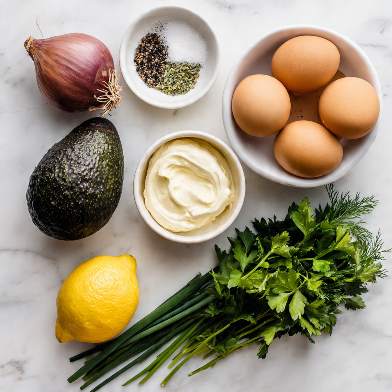 The image shows a top view of ingredients arranged neatly on a white marbled surface. In the center, there is a white bowl holding three brown boiled eggs. To the left, a full dark green avocado with a bumpy texture is placed beside a red onion with a smooth, shiny surface. Above the bowl, a small white bowl contains a mix of coarse salt and black pepper. Below the eggs, a small white bowl holds a dollop of creamy mayonnaise. On the right side of the image, a bright yellow lemon sits near a bundle of long, thin green chives. At the bottom, fresh green parsley leaves are spread out, showing their detailed shape and texture. photo taken with an iphone --ar 4:5 --v 7