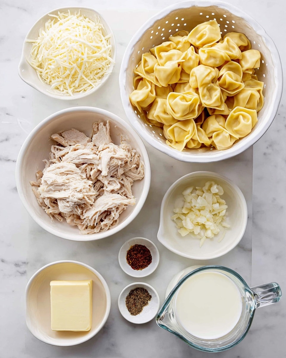 The image shows several white bowls and a clear measuring cup on a white marbled surface. There is a white colander filled with yellow tortellini pasta with folded, round shapes. Next to the colander, a white bowl holds shredded cooked chicken with light beige pieces. Above these, a white bowl contains shredded white cheese with long, thin strips. Another small white bowl holds minced garlic with a soft, pale yellow color. Next to it, a small white bowl contains a square piece of butter, pale yellow and smooth. A small white dish holds three spices: black pepper, white salt, and a reddish-brown seasoning, neatly divided. Finally, a clear glass measuring cup is filled with white milk. photo taken with an iphone --ar 4:5 --v 7