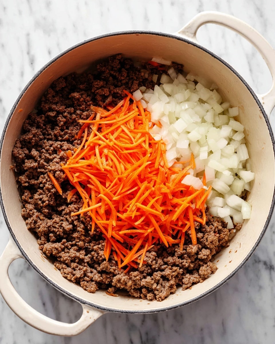 A large white pot with two handles sits on a white marbled surface. Inside the pot, there is a base layer of browned ground meat, coarse in texture and dark brown in color, occupying about three-quarters of the space. On top of the meat, diced white onions are layered in one section with small, translucent chunks. On top of the onions, there are bright orange shredded carrots, forming the top layer with thin, long strands. The layers remain separate and fresh looking. Photo taken with an iphone --ar 4:5 --v 7