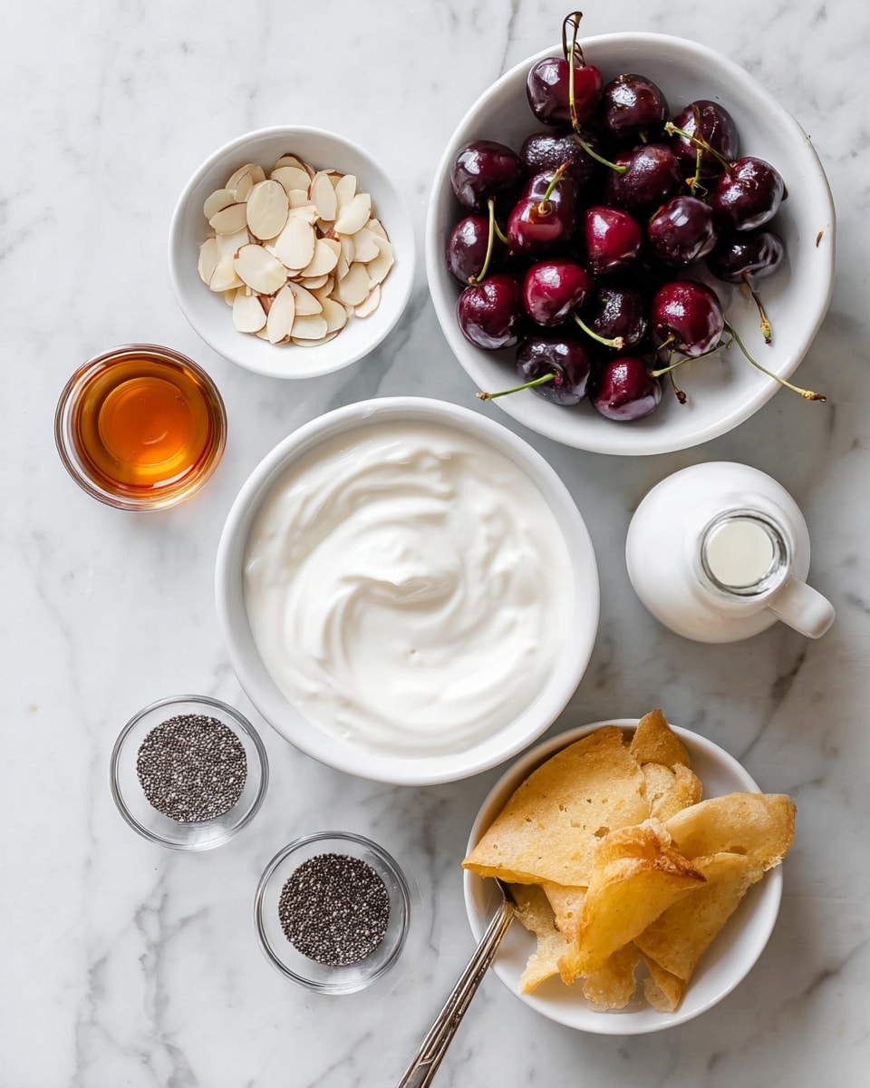 The image shows several ingredients arranged neatly on a white marbled surface. There is a large white bowl filled with smooth, creamy white yogurt in the center. To the top right, a white bowl holds shiny dark red cherries with green stems. A small white bowl at the top left contains pale beige slivered almonds. Below that, a small glass cup holds a clear amber liquid, possibly honey or syrup, and another tiny glass cup with a similar liquid is placed below it. Near the center bottom, a small white bowl is filled with tiny black and white chia seeds, with a silver spoon resting inside. Next to it, a small glass bottle is tilted, pouring white milk into a white bowl filled with golden, folded flatbread pieces. The overall look is clean and fresh. photo taken with an iphone --ar 4:5 --v 7