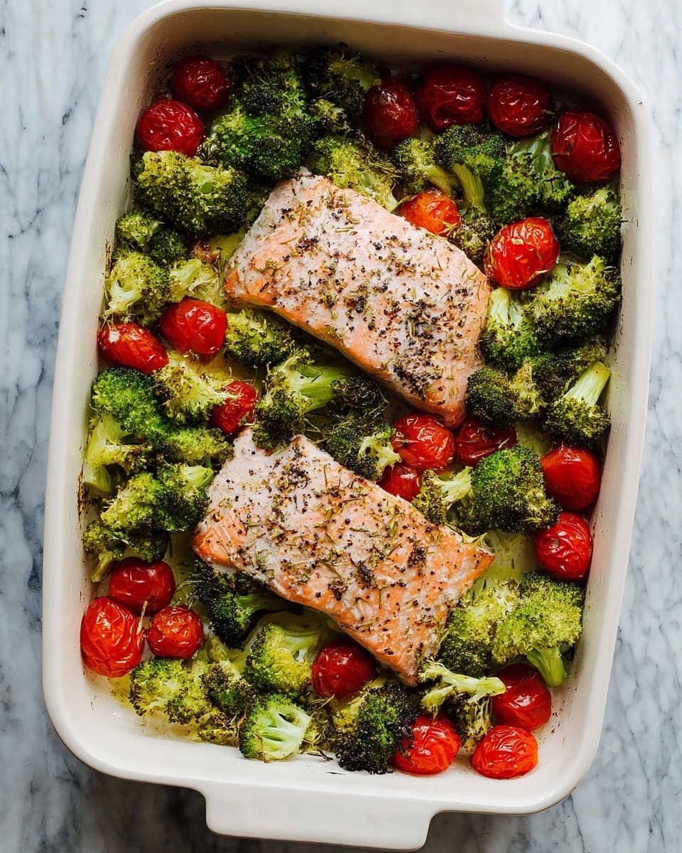 In a white rectangular baking dish, two pinkish-orange salmon fillets seasoned with black pepper sit in the center, surrounded by bright green roasted broccoli florets and vibrant red roasted cherry tomatoes scattered evenly around the edges. The broccoli has slightly charred dark tips, and the cherry tomatoes appear soft and blistered. The dish rests on a background with a white marbled texture. photo taken with an iphone --ar 4:5 --v 7