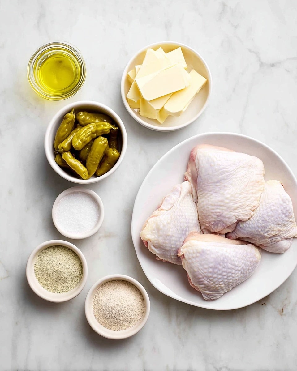 The image shows six main ingredients for a recipe laid out on a white marbled surface. On the right side, there is a white oval plate with four raw chicken thighs showing pale pink and white skin textures arranged neatly. To the left of the chicken, there are five small bowls: the top bowl contains several slices of pale yellow butter, the middle bowl has greenish-yellow whole peppers, the bottom left bowl holds a fine pale yellow powder, and the bottom right bowl has a light brown powder. In the top left corner, there is a small glass jar filled with golden olive oil. Photo taken with an iphone --ar 4:5 --v 7