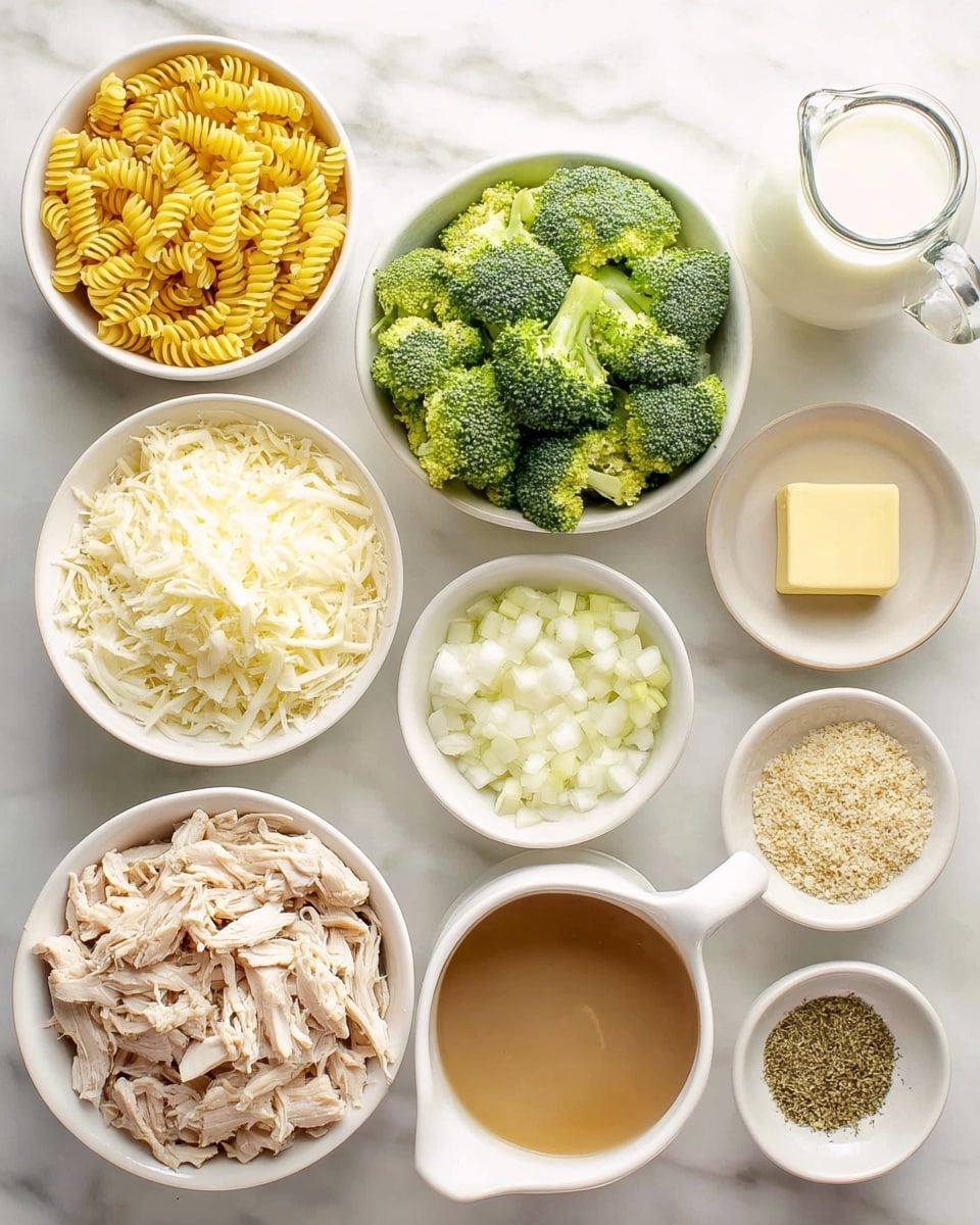 A top view of multiple white bowls arranged on a white marbled surface, each holding different ingredients. One bowl contains yellow spiral pasta, another has bright green broccoli florets, and there is a bowl with shredded light beige cooked chicken in the center. Nearby, a bowl holds finely chopped white onions, and another small bowl contains a square of pale yellow butter. There is a white jug filled with light brown broth, and smaller bowls with finely grated white cheese, minced garlic, white flour, and a mix of green and light brown dried herbs and spices. A glass jug filled with white milk is placed near the top right. The setup is bright and clean, suggesting preparation for cooking. Photo taken with an iphone --ar 4:5 --v 7
