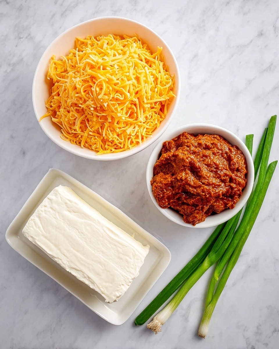 The image shows three white bowls and one white rectangular dish placed on a white marbled surface. The largest bowl is filled with finely shredded bright orange cheddar cheese, creating a fluffy texture. Next to it is a medium bowl filled with a thick, chunky reddish-brown sauce that looks rich and textured. Below them is a rectangular dish with a smooth block of white cream cheese. To the side are three fresh green onion stalks lying on the marbled surface, adding a pop of green color to the composition. photo taken with an iphone --ar 4:5 --v 7