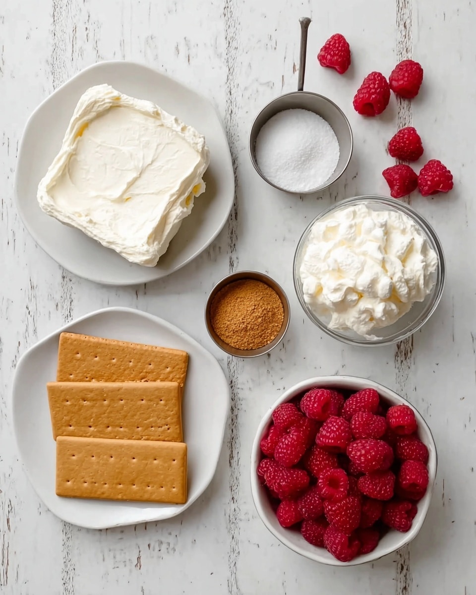 A top view of ingredients for a dessert arranged neatly on a white marbled surface: a white plate with a thick layer of cream cheese on the bottom left, two rectangular tan crackers placed below it, a glass bowl filled with a fluffy white cream texture on the bottom right, a white bowl full of bright red raspberries on the top right, and two small metal cups containing a brown crumbly powder placed side by side near the right center. Another metal cup with white sugar is near the top left. A few loose raspberries are scattered near the top right edge. photo taken with an iphone --ar 4:5 --v 7