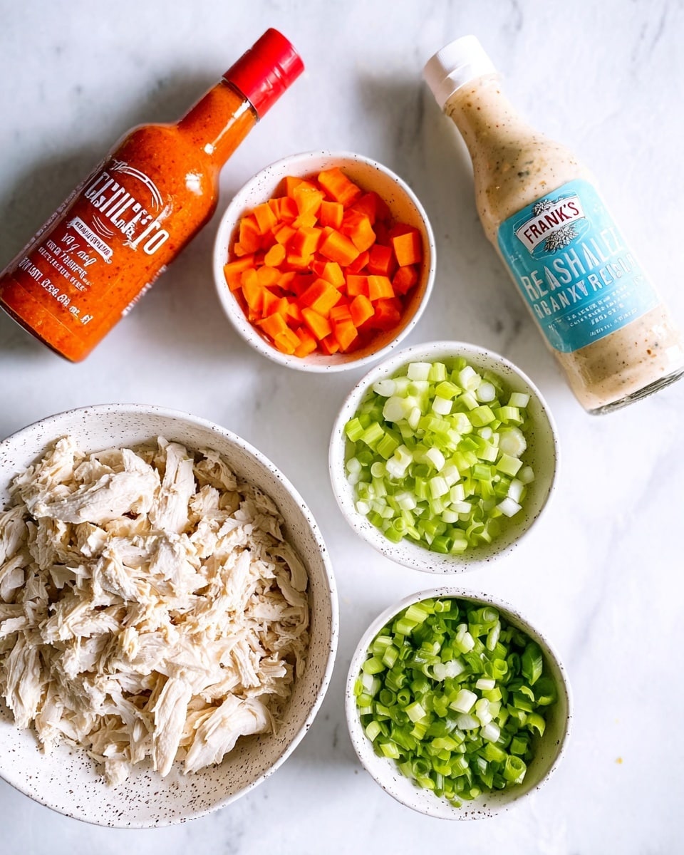 The image shows a white speckled bowl filled with shredded white chicken pieces as the main item. Above the bowl, there are three smaller white bowls, each containing diced vegetables: bright orange carrots on the left, light green celery in the middle, and chopped green onions on the right. To the left of the bowls is a large orange bottle of Frank’s RedHot Original sauce, and on the right is a tall bottle of Tessemae’s Pantry Classic Ranch dressing with a blue label. All items are placed on a white marbled surface. photo taken with an iphone --ar 4:5 --v 7