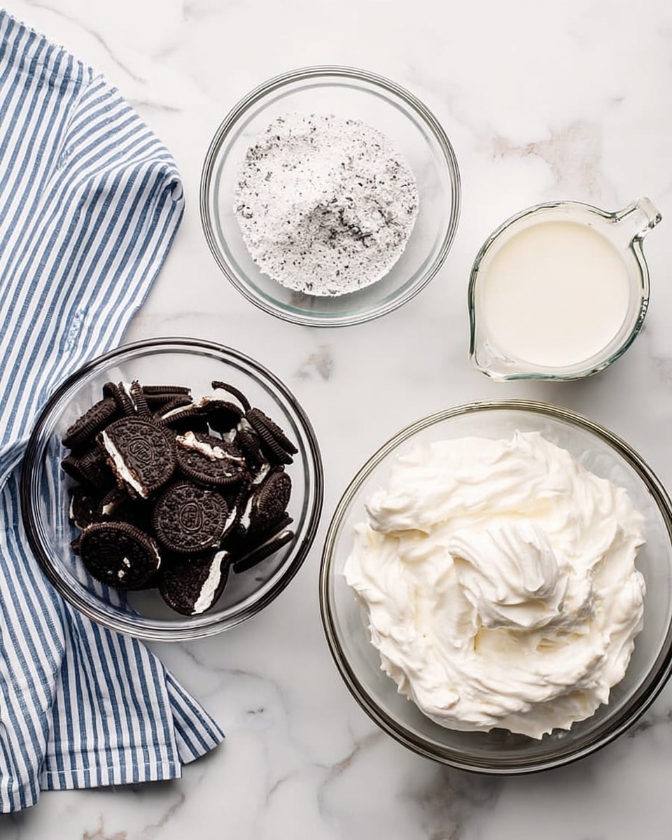 The image shows four clear round glass bowls arranged on a white marbled surface. The bottom left bowl is filled with large broken dark chocolate sandwich cookies with white cream visible inside. The top center bowl contains white powder, likely flour, with some small dark specks mixed in. The bottom right bowl is filled with a thick, smooth, white whipped mixture. The top right bowl is a clear glass measuring cup holding white milk. A blue and white striped cloth is on the upper left edge of the frame. photo taken with an iphone --ar 4:5 --v 7