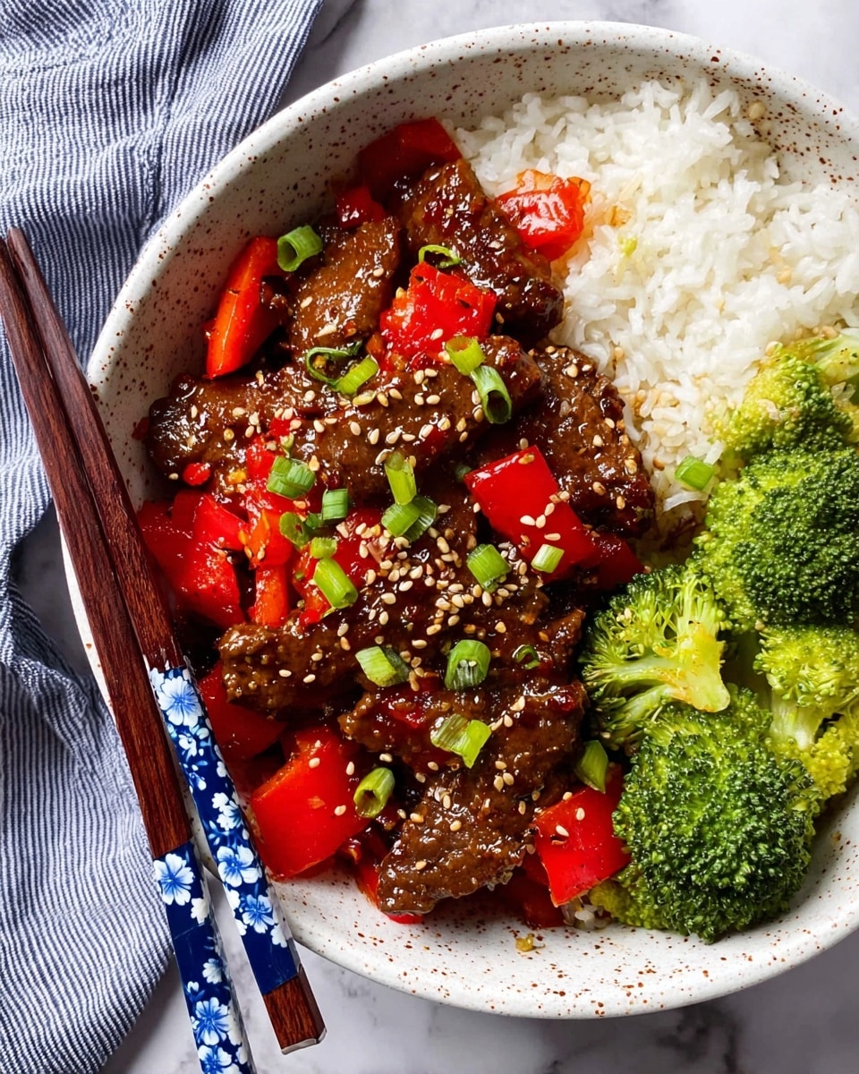 The image shows a cast iron pan filled with a colorful stir-fry dish. The bottom layer consists of glossy dark brown beef strips coated in a rich sauce, mixed with bright red bell pepper chunks. Scattered on top are small white sesame seeds and thin slices of fresh green onion. On the center of the dish, two thin slices of lime rest, adding a fresh touch. A wooden spatula is partially dipped inside the pan on the right side. The pan sits on a white marbled surface, with a bowl of fluffy white rice visible in the upper left corner and another bowl with green onions partially shown on the right side. Photo taken with an iphone --ar 4:5 --v 7