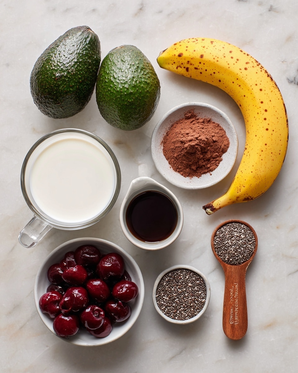 The image shows various ingredients placed on a white marbled surface. There are two dark green avocados positioned near the top left. Beside them is a yellow banana with small brown spots. Below the banana and avocados is a clear glass filled with white oat milk. Next to the glass, on the right, is a tablespoon with brown cocoa powder, and to its right is a small white bowl with dark maple syrup. Below the syrup is a small gray cup with dark vanilla extract. Beneath these small containers is a white bowl filled with dark red chopped cherries. To the right of the cherry bowl is a wooden-handled measuring spoon full of small gray chia seeds. All items are neatly spaced in a flat lay style. Photo taken with an iphone --ar 4:5 --v 7