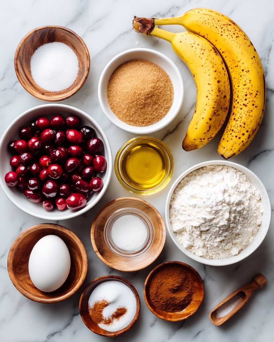 The image shows an overhead view of several baking ingredients arranged neatly on a white marbled surface. There are three yellow bananas with brown spots at the top right, a white bowl filled with light brown sugar next to the bananas, and a small wooden bowl with white salt near the top left corner. A white bowl of white flour sits near the bottom right, while a clear glass container with light golden oil is placed on the left side. Near the bottom left is a white bowl full of red cranberries. There is one white egg positioned near the center and a small white bowl with brown cinnamon powder near the bottom right. A tiny wooden scoop holds amber vanilla extract beside the flour, and small wooden bowls hold white baking soda near the center and brown sugar near the top left. The ingredients are labeled with simple black text showing their amounts. photo taken with an iphone --ar 4:5 --v 7
