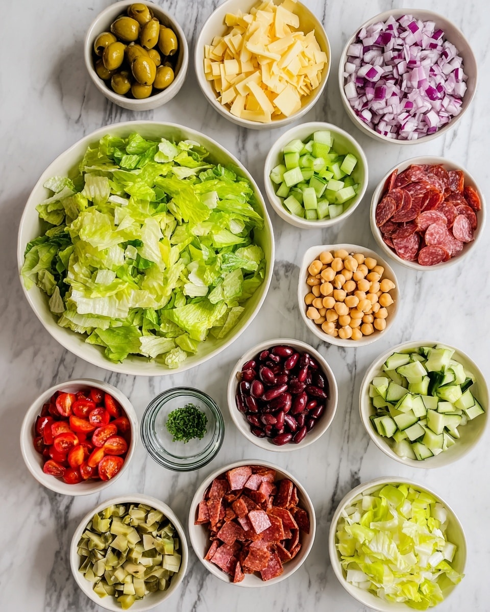 This image shows many small white bowls and one white plate with different salad ingredients arranged on a white marbled surface. At the center is a large white bowl filled with bright green chopped lettuce. Around it, starting from top left and moving clockwise, there are bowls with small chopped purple onions, sliced green olives, chopped green cucumbers, pale yellow shaved cheese, pale yellow cubed cheese, small red cherry tomato halves, chopped red and white radicchio leaves in a white bowl, small chopped red bell pepper pieces, round beige chickpeas in a glass bowl, small diced reddish salami pieces in a white bowl, shredded pale green iceberg lettuce in a white bowl, chopped light green pickles, and dark red kidney beans. In the middle near the top, there is a small glass bowl with finely chopped green herbs. The bowls and plate are clean and neatly arranged. Photo taken with an iphone --ar 4:5 --v 7