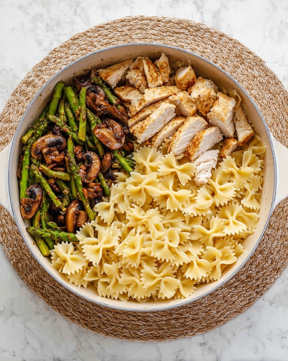 A white pan filled with three main parts: a layer of pale yellow farfalle pasta on the right side with a smooth texture, above it on the top right, there is a layer of sliced cooked chicken with a golden brown outer color and white inside showing a firm texture, and on the left side, a layer of cooked green asparagus pieces mixed with brown sautéed mushrooms creating a slightly charred look. The pan is placed on a round beige woven mat on a white marbled surface. photo taken with an iphone --ar 4:5 --v 7
