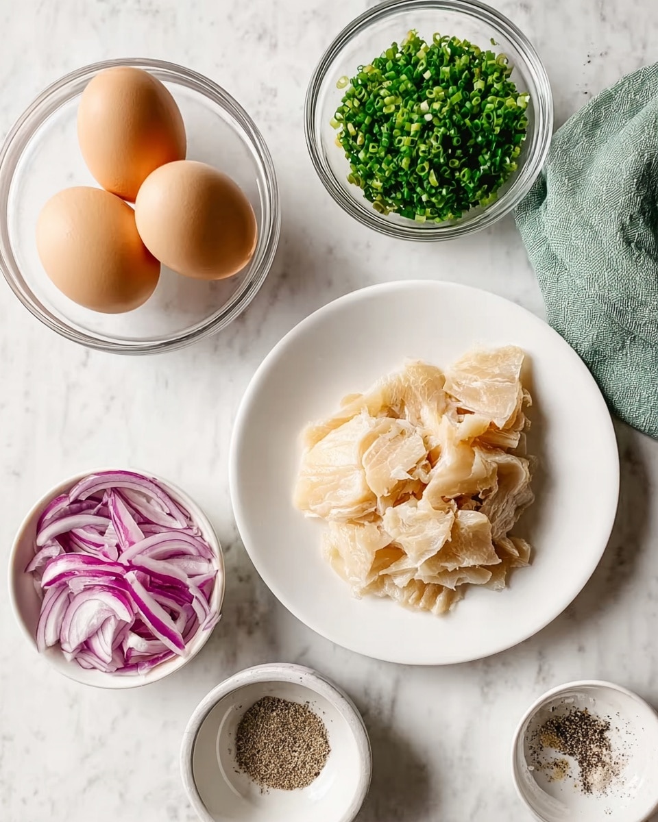The image shows five main ingredients arranged on a white marbled surface. At the center bottom, a white plate holds several flakes of light beige cooked fish with a tender texture. To the top left, a clear glass bowl contains four brown eggs. To the right of the eggs, a small white bowl is filled with chopped green chives. Below the chives, another small white bowl holds coarse salt and black pepper mixed side by side. At the bottom left, a fourth small white bowl contains thinly sliced strips of red onion with vivid purple and white layers. There is a small piece of green cloth in the top right corner. Photo taken with an iphone --ar 4:5 --v 7