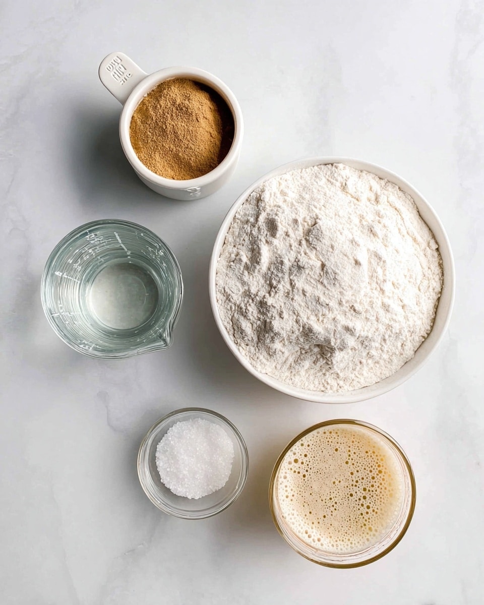 The image shows four bowls and a measuring cup arranged on a white marbled surface. On the top right is a large white bowl filled with a white, powdery flour, with a slightly uneven surface. To its left is a white measuring cup filled with a brown powder, likely a spice or ground ingredient. Below the measuring cup is a small clear glass bowl containing a white granular substance, probably salt. On the bottom left, there is a glass measuring cup with clear water. On the bottom right, there is a small transparent glass filled with a bubbly, beige liquid, possibly yeast mixture. photo taken with an iphone --ar 4:5 --v 7