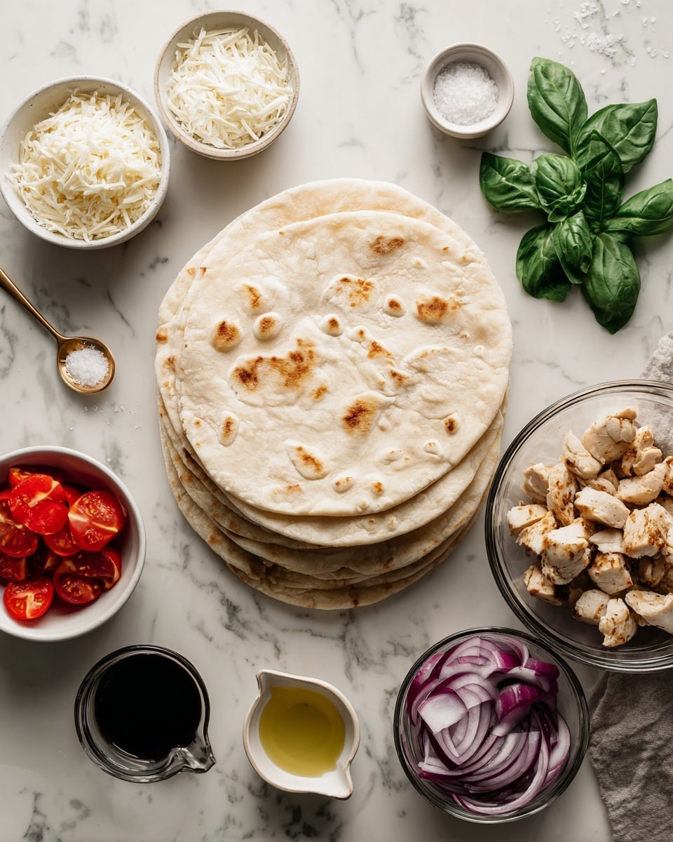 A stack of round pita bread sits in the center on a white marbled surface, surrounded by small white bowls and clear glass bowls holding ingredients: finely shredded white mozzarella cheese in a bowl at the top left, bright red halved cherry tomatoes in a bowl at the bottom left, and thinly sliced purple red onion in a glass bowl at the bottom right. To the right of the pita rounds is a glass bowl filled with golden-brown cooked chicken pieces. Fresh green basil leaves lie just above the red onion. A small white dish of golden olive oil is at the bottom center, and a small white measuring cup containing a dark balsamic glaze is placed to the left of the pita rounds. Above the chicken is a small gold spoon holding flaky white salt. The overall layout is neat with natural light, photo taken with an iphone --ar 4:5 --v 7