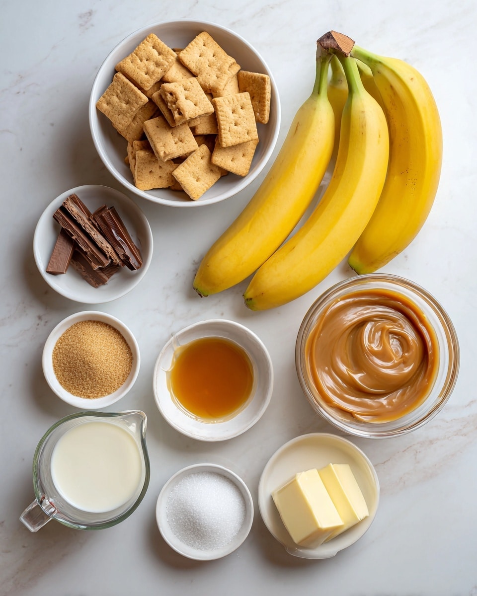 The image shows a flat lay of ingredients arranged on a white marbled surface. In the center top is a white bowl filled with square golden brown biscuits. To the left of the biscuits is a small white bowl holding broken sticks of light brown chocolate. Below the biscuits and chocolate, a bunch of three bright yellow bananas with brown stems lays flat. To the right of the bananas is a clear glass bowl with light brown caramel that has a smooth and slightly lumpy texture. Below the caramel are three small white bowls arranged in a triangle: one with light brown granulated brown sugar, one with white powdered icing sugar, and one with amber-colored vanilla extract. At the bottom left corner is a clear measuring cup filled with cream. At the bottom right corner is a small white bowl with a pale yellow stick of butter. Near the center, just below the bananas, is a small white bowl containing pale yellow lemon juice. The labels for each ingredient float near them in black text. The overall setting is bright and clean with soft natural light. Photo taken with an iphone --ar 4:5 --v 7