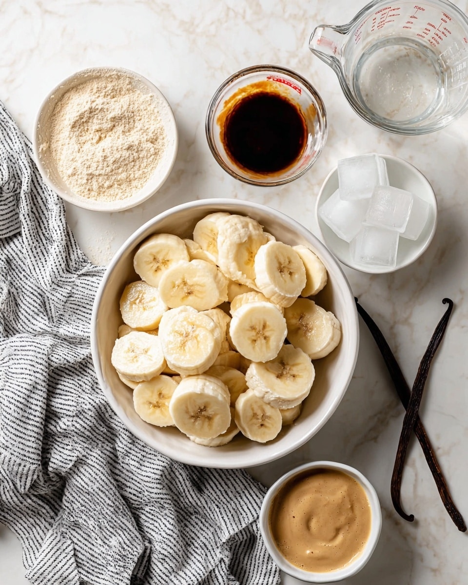 The image shows a white bowl filled with thick slices of banana arranged in a slightly uneven heap. Around the bowl, there are several small white bowls and a glass measuring jug on a white marbled surface. One bowl contains a light brown powder, another has a dark brown liquid, and a third one holds a creamy brown sauce. In the top right corner, a small white bowl with two ice cubes is visible beside two vanilla pods lying flat. A gray and white striped cloth is placed near the bowl of bananas. Photo taken with an iphone --ar 4:5 --v 7