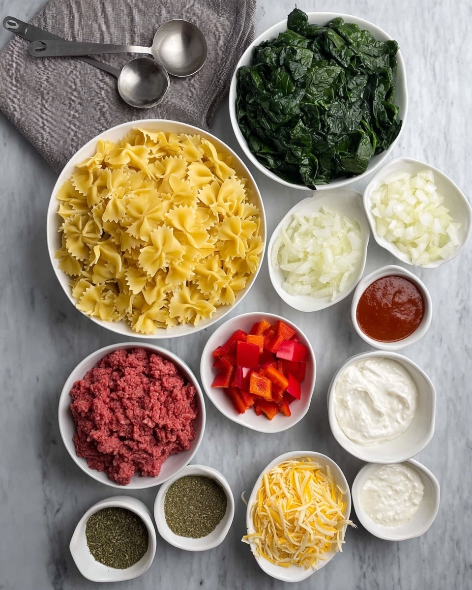 The image shows a top view of various cooking ingredients placed on a white marbled surface. In the center, there is a white bowl filled with dry yellow farfalle pasta. Above it to the right is a white bowl with chopped green leafy spinach, and next to that is a small white bowl containing chopped white onions. Below the spinach, there is a small white bowl holding diced red bell peppers. Towards the bottom center, a white bowl is filled with raw red ground meat. Near the meat, there is a small white bowl with dried green herbs. Next to this are three small white bowls with different ingredients: one with tomato paste in deep red, one with shredded light yellow cheese, and two oval bowls with white creamy substances, likely ricotta and sour cream or yogurt. A set of metal measuring spoons rest on a grey cloth to the top left corner. The photo taken with an iphone --ar 4:5 --v 7