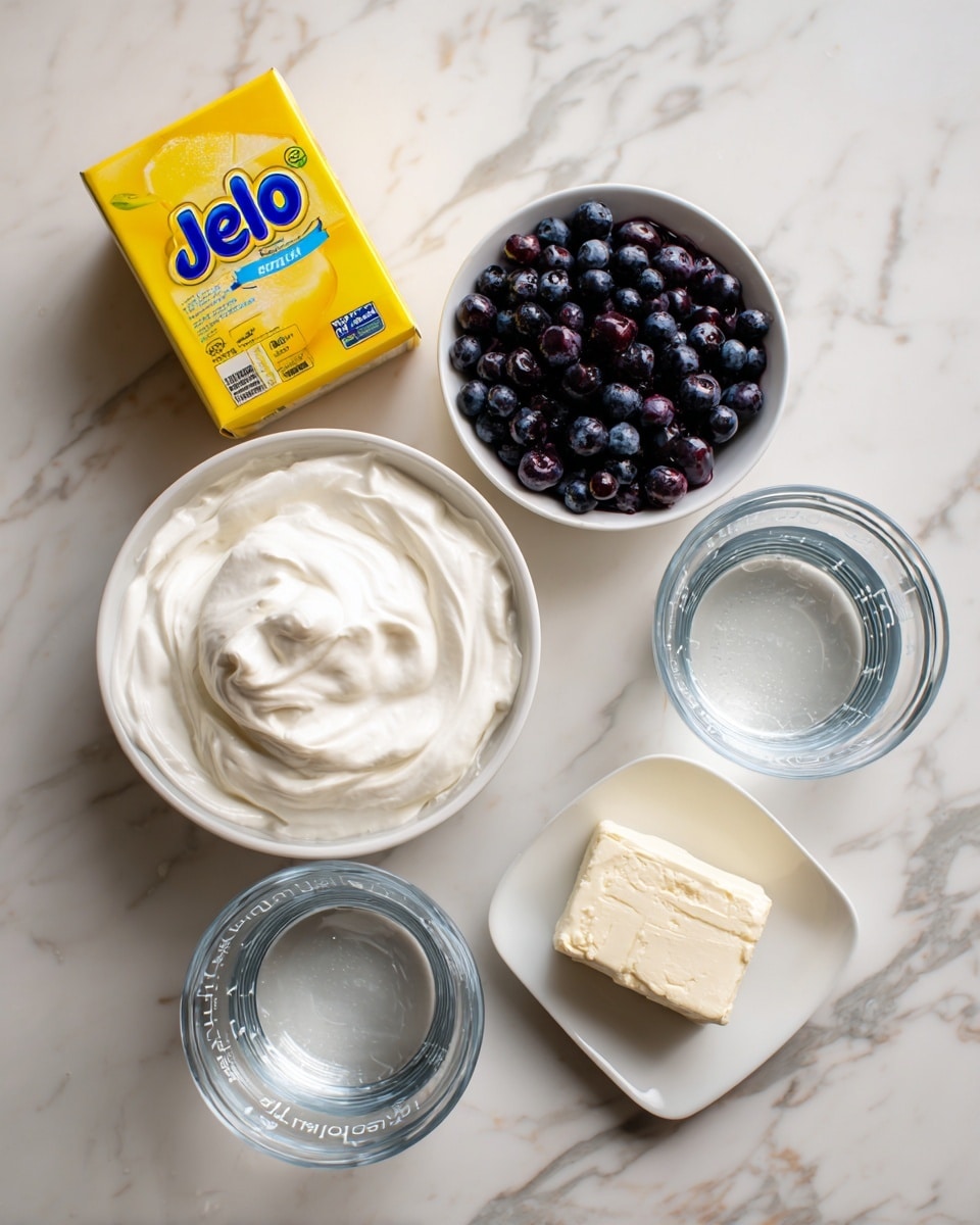 The image shows six ingredients neatly placed on a white marbled surface. At the top left, there is a yellow lemon Jello box. To the right, a small white bowl holds fresh dark blue berries. In the center, a round white bowl filled with smooth, white cool whip is positioned. Below it, two clear glass measuring cups are filled with clear liquids labeled boiling water on the left and cold water on the right. At the bottom center, a small white dish contains a block of creamy, pale cream cheese. The arrangement is clean and organized with each ingredient clearly labeled. photo taken with an iphone --ar 4:5 --v 7
