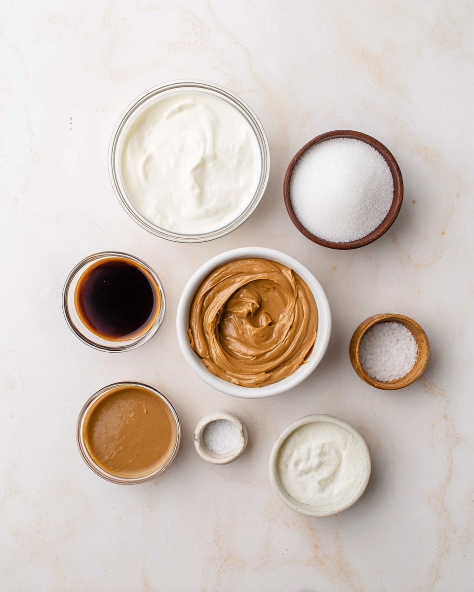 The image shows seven small bowls with different ingredients arranged on a white marbled surface. In the center, there are two clear glass bowls with a white creamy liquid inside, one placed above the other. To the right of the top glass bowl is a brown bowl filled with white granulated sugar. Below it, a white bowl holds smooth brown peanut butter with visible swirls. To the left of the peanut butter, there is a small white bowl with a dark brown liquid, likely vanilla. Above it and to the left of the glass bowls, there is a smaller brown bowl with brown mustard or similar thick sauce. Below the glass bowls is a clear bowl with a fine white powder, and next to this is a tiny white bowl with salt. The setting is bright and clean with soft natural light, photo taken with an iphone --ar 4:5 --v 7