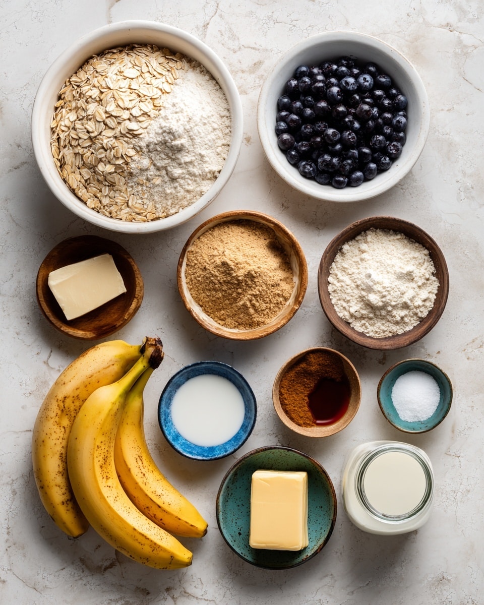 A top-down view of various baking ingredients is shown arranged neatly on a white marbled surface. A large white round bowl on the top left contains rolled oats on the left side and all-purpose flour on the right side, both with a rough texture and soft beige and white colors. To the right of this bowl, there is a small white bowl filled with dark blue blueberries. Below that, three ripe bananas with brown spots lie side by side. Several small wooden bowls hold golden oil, light brown sugar with a crumbly texture, and a pale yellow block of unsalted butter. Two small blue bowls contain white baking soda and baking powder powders, while a small yellow bowl has salt crystals. A glass jar with white buttermilk, a small brown bowl with ground cinnamon powder, a small green bowl with dark brown pure vanilla extract, and a brown bowl with a single brown egg complete the circle of ingredients. All items are spaced with visible white marble in the background. Photo taken with an iphone --ar 4:5 --v 7