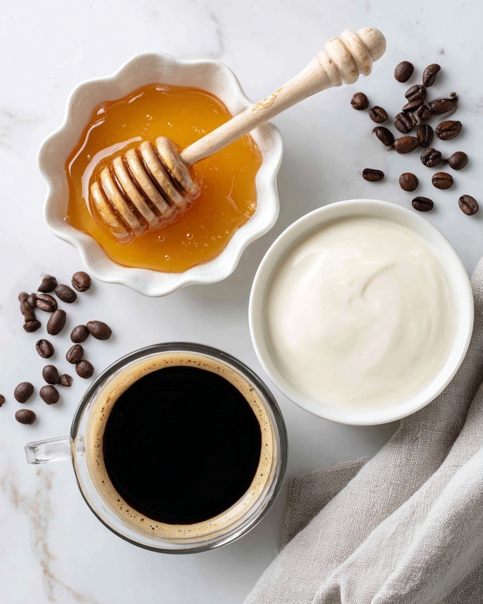 The image shows three separate small white dishes arranged on a white marbled surface. On the top left, a white scalloped ceramic bowl holds golden honey with a wooden honey dipper resting inside, its ridges coated with the honey. To the right of that, a white round bowl is filled almost to the top with creamy whole milk, smooth and glossy on the surface. Below these two, a small clear glass cup contains a dark black espresso, shiny and dense with no foam. Coffee beans are scattered lightly near the bowls, adding a dark brown contrast to the scene, with a soft gray cloth folded on the bottom right of the image. Photo taken with an iphone --ar 4:5 --v 7