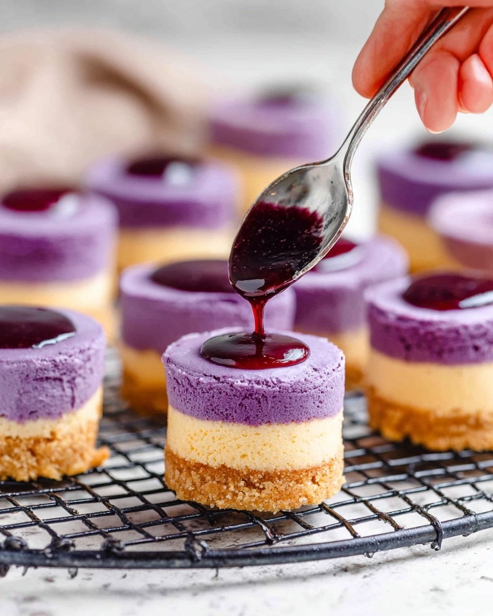 A dark metal muffin tray with twelve sections sits on a white marbled surface. The top six sections are filled with a smooth, purple batter, while the bottom six sections contain a creamy white batter. A woman's hand holding a spoon is adding purple batter over the white batter in one of the bottom sections. Next to the tray is a clear bowl filled with more purple batter. A white and gray striped cloth is partially visible in the upper right corner. photo taken with an iphone --ar 4:5 --v 7