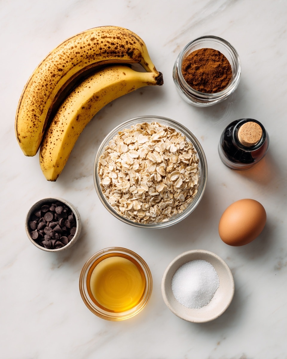 The image shows several ingredients arranged neatly on a white marbled surface. At the top left, there are three overripe bananas with brown spots on their yellow skins. In the center, there is a clear round bowl filled with quick-cooking oatmeal, light beige in color with a rough texture. To the right of the oatmeal, there is a cinnamon powder jar with a dark brown spice inside and a vanilla extract bottle next to it, both standing upright. Below the oats, on the left, a small bowl filled with dark chocolate chips is visible. In the middle below the oatmeal, there is a small glass bowl with golden honey. To the right of the honey, a small round clear bowl holds a brown egg. On the far right, there is a small salt container with white salt inside. The arrangement is clean and simple, with each ingredient clearly visible and labeled. Photo taken with an iphone --ar 4:5 --v 7