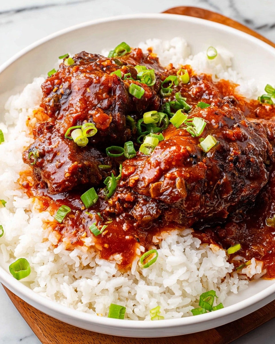 Inside a black slow cooker, there are six pieces of cooked chicken thighs in rich, thick, dark reddish-brown sauce. The sauce looks smooth and shiny with some small bits in it. Bright green chopped scallions are sprinkled over the chicken, adding a fresh color contrast. The slow cooker sits on a white marbled surface with a wooden spoon next to it. Photo taken with an iphone --ar 4:5 --v 7
