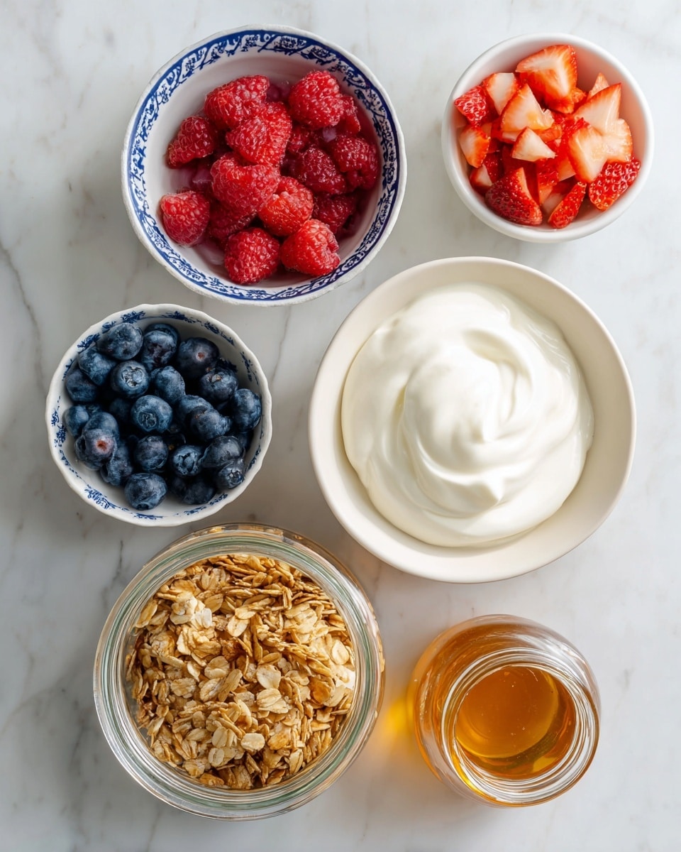 The image shows five white bowls and jars on a white marbled surface, each containing different ingredients. The largest bowl to the right holds smooth, thick plain Greek yogurt swirled gently on top in a creamy white color. Below it, a clear glass jar is filled with golden brown granola, showing small clusters and oats. To the left, a white bowl with a blue pattern around the rim contains fresh fruit of bright red raspberries and deep blue blueberries, creating a colorful mix. Above that, a smaller white bowl with a thin blue rim is filled with diced red strawberries. Next to the bowl of diced strawberries is a small glass bottle filled with light amber honey. The setup is neat and bright, all placed on a clean white marbled surface photo taken with an iphone --ar 4:5 --v 7