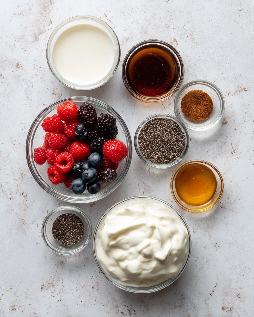 A white marbled surface with seven clear glass bowls arranged across it, each bowl filled with a different ingredient: the top right bowl contains dark brown maple syrup, below it a smaller bowl holds small black and white chia seeds; near the center, a tiny bowl has a small amount of brown cinnamon powder; below and to the left, a medium bowl is filled with bright red mixed berries including strawberries, raspberries, and blueberries; a larger bowl at the bottom contains thick white yogurt with a soft texture; above the yogurt bowl, another bowl holds white milk; and near the top left, a small bowl has dark amber vanilla extract. Each ingredient is labeled in simple black text. Photo taken with an iphone --ar 4:5 --v 7