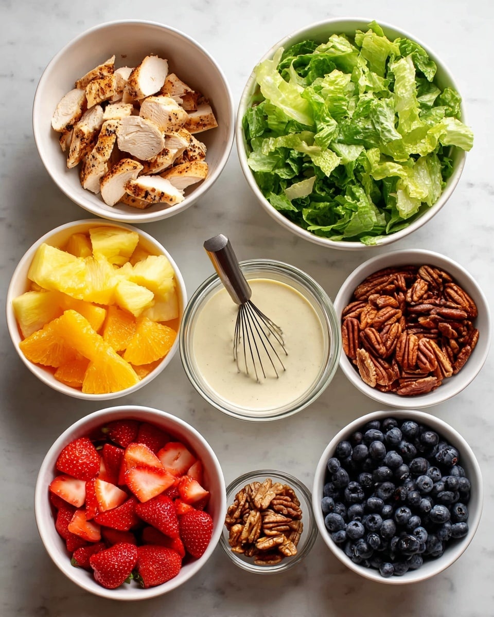 The image shows eight white bowls arranged on a white marbled surface. Starting from the top left, the first bowl contains light brown grilled chicken slices with a slightly charred texture. To its right, there is a bowl filled with fresh, unevenly chopped green lettuce leaves that look crisp. Next to it is a clear glass bowl with creamy white dressing and a black whisk inside. Below these, from left to right, the bowls hold bright yellow pineapple chunks, vibrant red strawberry halves, bright orange mandarin segments, rich brown pecan nuts, and dark blue whole blueberries. All items appear fresh and neatly placed. Photo taken with an iphone --ar 4:5 --v 7