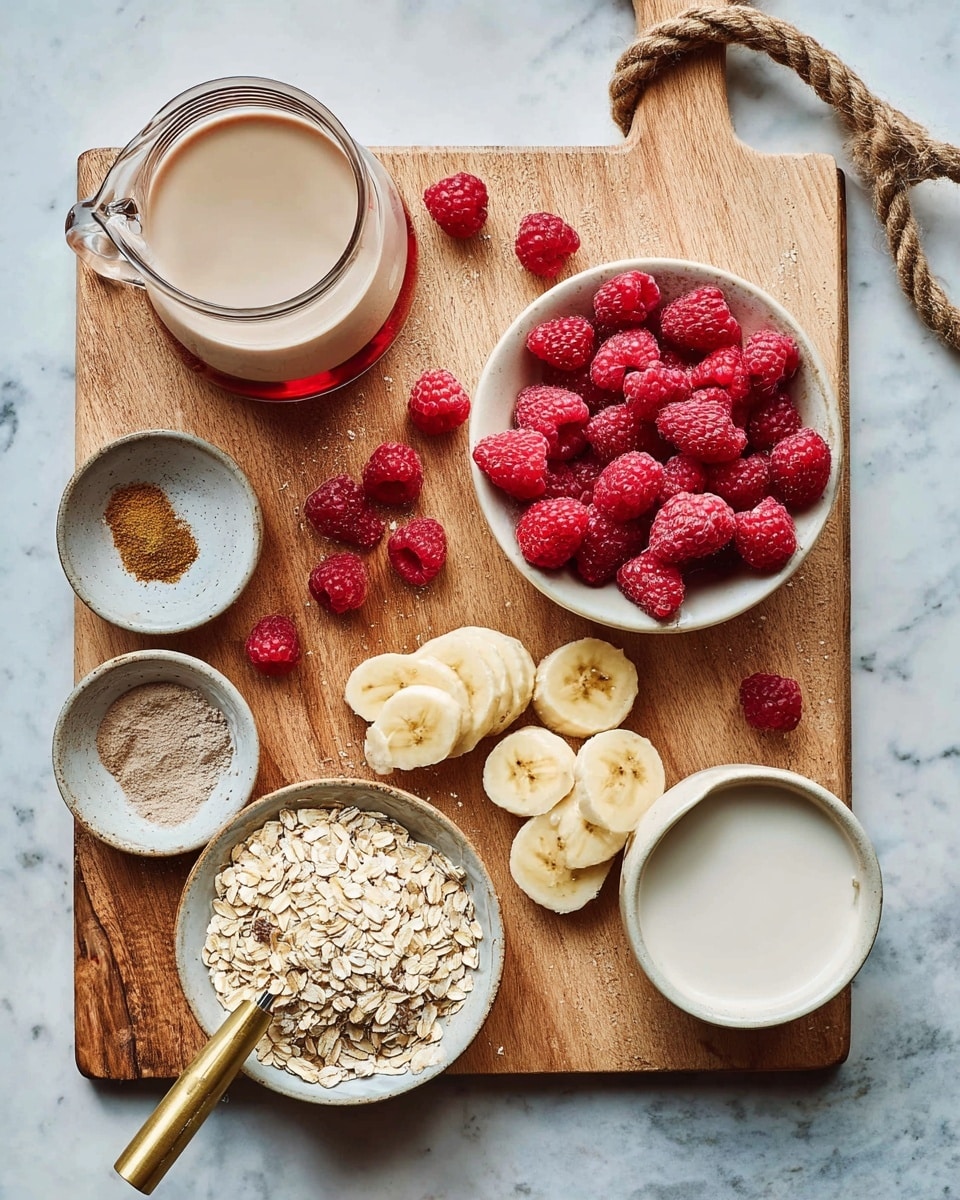 The image shows a clean wooden board on a white marbled surface, featuring fresh bright red raspberries piled in a beige bowl placed on the top right, next to scattered raspberries around the board. Below the bowl, several slices of yellow banana with a soft texture are spread on the board and spilling slightly off the edge. At the bottom right, there is a glass jar filled with light tan rolled oats, with a gold-handled measuring spoon heaped with oats resting on the board. On the left side of the board, a small round white bowl contains three different powdered spices in earth tones: brown, dark brown, and light beige. Above that, there is a white cream pitcher filled with a frothy beige liquid, and below it, a white round bowl holds a smooth creamy white substance. In the upper center of the image, a small clear glass bottle with a reddish-brown liquid inside is placed on the board, with a textured brown rope loop attached to the handle of the wooden board visible at the top right. The whole setup is bright, fresh, and clearly organized. photo taken with an iphone --ar 4:5 --v 7