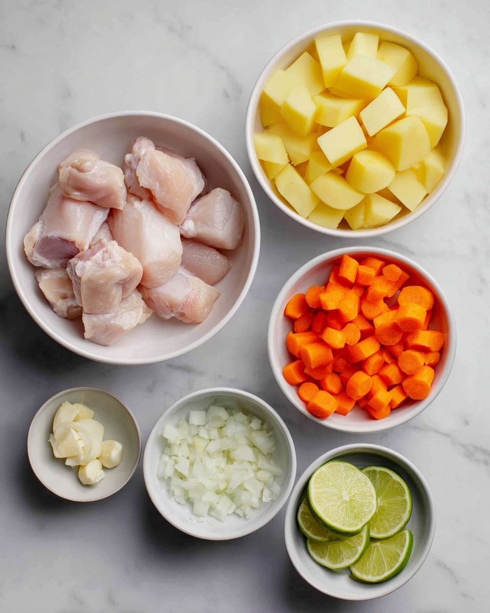 The image shows six white bowls on a white marbled surface, each containing different ingredients. The largest bowl, placed on the left, holds raw chicken pieces that are light pink and smooth in texture. Above it, a medium bowl is filled with peeled and chopped yellow potatoes, cut into irregular cubes. To the right, another medium bowl contains bright orange carrot slices that are cut into thick rounds. Next to it, a small bowl holds finely chopped white onions with a slightly translucent look. Below that, another small bowl contains minced garlic with a creamy white color and soft texture. Finally, the smallest bowl on the lower right has three lime wedges with green skin and juicy pale green flesh. All bowls are neatly arranged and the lighting is soft, creating mild shadows. Photo taken with an iphone --ar 4:5 --v 7