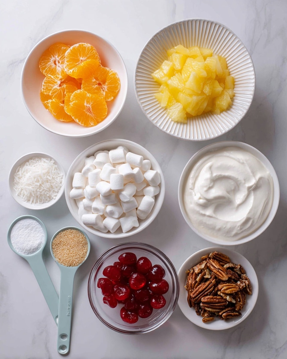 The image shows seven ingredients arranged neatly on a white marbled surface. At the top left, a white bowl holds bright orange mandarin orange slices, while next to it on the right, another white bowl contains crushed pineapple with a yellow, pulpy texture. Below, a white ribbed plate is filled with small, white mini marshmallows. Next to it on the right, a white bowl is filled with smooth, white whipped topping. Below these, a small clear glass bowl holds shiny, chopped red cherries. To the left of the cherries, two light blue measuring spoons contain shredded white coconut and brown pecans. Finally, at the bottom right, there is a crinkled golden-brown packet labeled pudding mix. Photo taken with an iphone --ar 4:5 --v 7