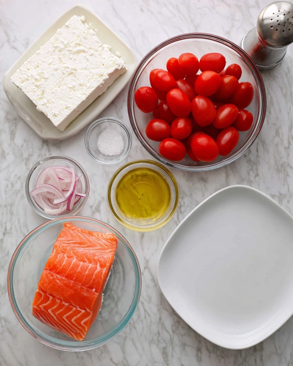 The image shows ingredients arranged on a white marbled surface, ready to make a dish. There is a clear bowl with a bright orange piece of raw salmon with visible white lines, positioned near the center bottom. Above it, there is a clear bowl filled with bright red grape tomatoes, smooth and shiny. To the left of the salmon, there is a white block of feta cheese with a crumbly texture in a clear bowl. Nearby are three smaller clear bowls with one containing thin pale pink slices of onion, another with golden olive oil, and one with coarse white salt. A tall silver pepper grinder stands near the bowls. On the right side of the image is a large empty white plate with a smooth surface. photo taken with an iphone --ar 4:5 --v 7