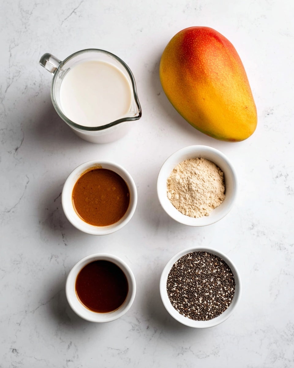 On a white marbled surface, there is one whole mango with a yellow and red color placed diagonally near the center. Around it, five small white bowls and a clear glass pitcher are arranged neatly. The glass pitcher at the top left holds a white liquid, likely milk. To the top right, a white bowl contains a thick brown syrup. Below it, another white bowl is filled with a beige powder. At the bottom left, a white bowl has a dark brown liquid. Finally, at the bottom right, a white bowl is filled with small black and white chia seeds. The items are spaced evenly, creating a clean and simple layout photo taken with an iphone --ar 4:5 --v 7