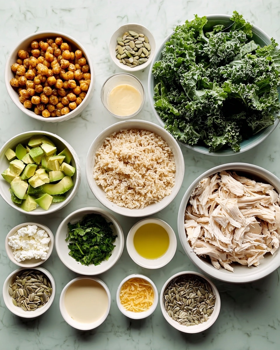 A top view of several white bowls arranged neatly on a white marbled surface, each holding different ingredients: one bowl is full of torn green kale leaves with a rich texture, another with shredded white chicken pieces lies to the right, and a bowl filled with light brown cooked rice sits below the chicken. To the left, a bowl contains golden-brown roasted chickpeas with a crispy look, above it a bowl with bright green avocado cubes. Smaller bowls are filled with chopped green herbs, white crumbled cheese, light yellowish garlic cloves, creamy beige sauce, honey, light-colored oil, white salt, sunflower seeds, and a pinch of yellow spice powder. The setup shows a clean and fresh preparation of ingredients for a meal. Photo taken with an iphone --ar 4:5 --v 7