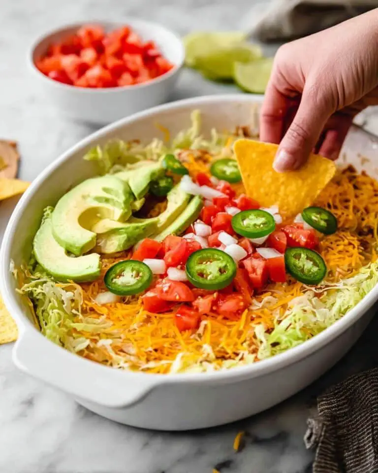 Creamy Taco Dip with Cheddar, Avocado, and Fresh Toppings Recipe