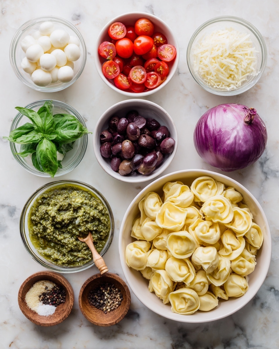 The image shows a white bowl filled with pale yellow tortellini placed on the right side on a white marbled surface. Surrounding the bowl are small white bowls and clear glass bowls with different ingredients: bright red cherry tomatoes cut in halves in a white bowl, dark purple sliced olives in a glass bowl, pale green fresh basil leaves in a white bowl, small white mozzarella pearls in a glass bowl, finely shredded white parmesan cheese in a glass bowl, a whole purple red onion, a small white bowl with smooth bright green pesto, and two small wooden bowls with coarse white salt and mixed black and brown peppercorns, each with a small wooden scoop. photo taken with an iphone --ar 4:5 --v 7