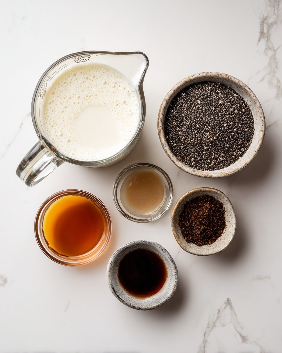 The image shows five clear glass containers placed on a white marbled surface. The largest container is a measuring cup with white milk, slightly frothy on top, positioned in the upper left. To its right is a medium bowl filled with small, round black chia seeds. Below, three small bowls are arranged: the left one holds dark brown vanilla liquid, the middle one contains light brown maple syrup, and the right one has a small amount of dark brown chai spice powder. Each container is clearly labeled with its content. photo taken with an iphone --ar 4:5 --v 7