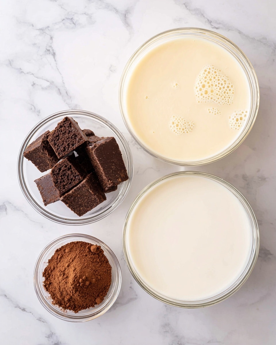 Four clear glass bowls sit on a white marbled surface. The largest bowl in the bottom right holds a smooth, creamy white liquid. The second largest bowl in the top right contains a light beige liquid with small bubbles on the surface. In the top left, a smaller bowl is filled with uneven, chunky dark brown pieces. Below that, another small bowl holds fine, powdery brown cocoa. The bowls are arranged close together, showing a mix of smooth liquids and textured solids. Photo taken with an iphone --ar 4:5 --v 7